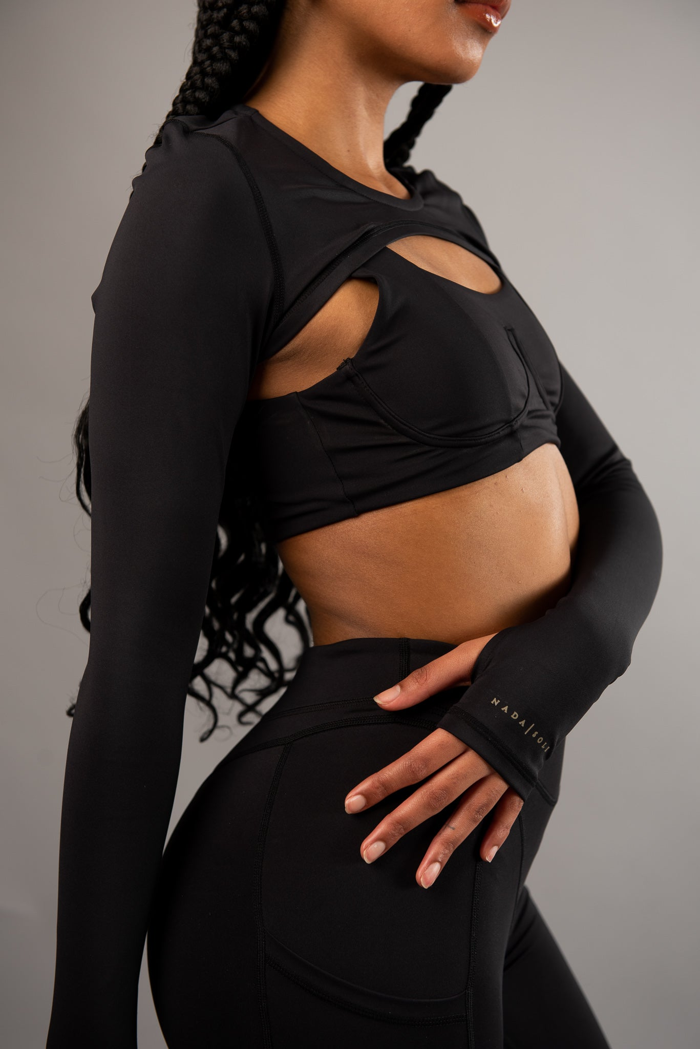 woman in turquoise blue workout clothes holding water bottle 